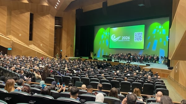 people are gathered in a large theatre space