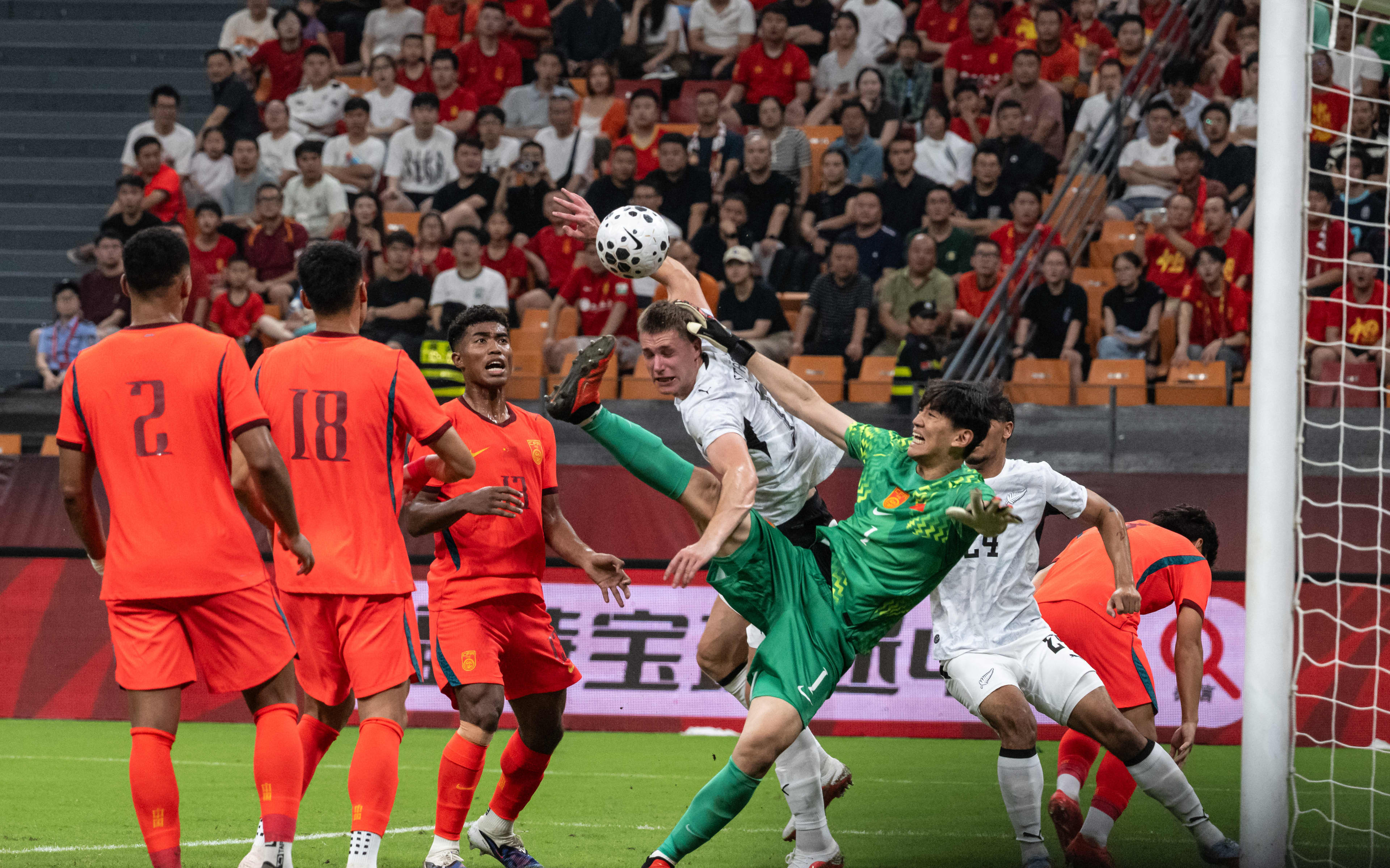 New Zealand’s George Stanger takes on Chinas goalkeeper Yan Junling.