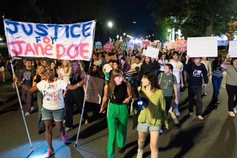 People march and hold signs saying 'Justice for Jane Doe'